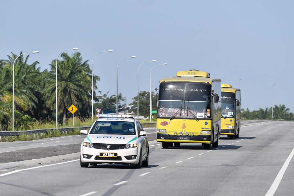 Buses ferrying the second batch of Malaysians brought home from Wuhan are pictured on the way to the Higher Education Leadership Academy in Nilai February 26, 2020. u00e2u20acu2022 Bernama pic