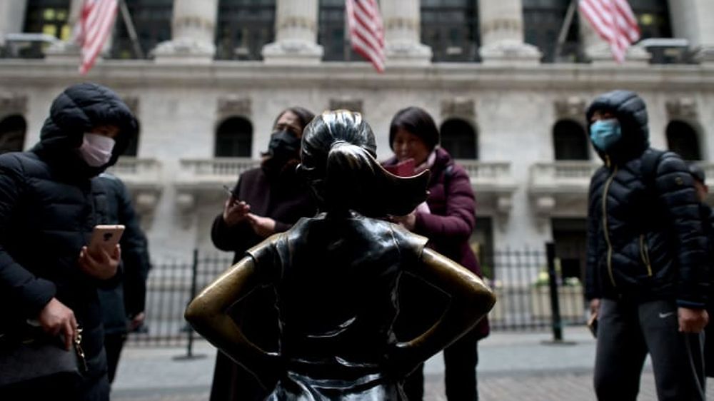 Chinese tourists with facial masks stand in front of the New York Stock Exchange (NYSE) on February 3, 2020 at Wall Street in New York City. u00e2u20acu201d AFP pic