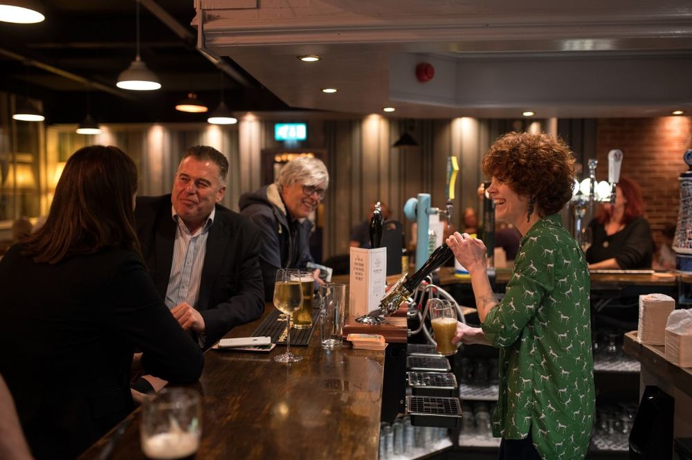 Landlady Abigail Bennett works behind the bar in the community-owned Ye Olde Cross pub in Ryton village, near Newcastle upon Tyne, in north east England on February 5, 2020. u00e2u20acu201d AFP pic