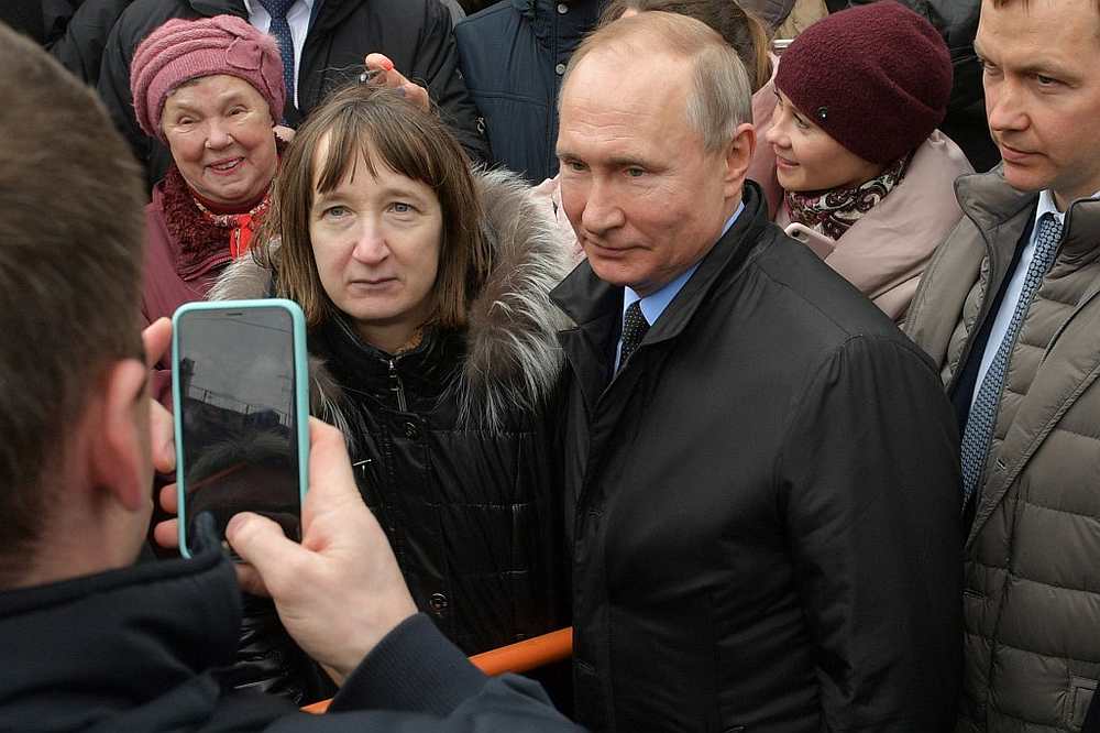 Russian President Vladimir Putin poses for pictures with locals after laying flowers at a monument to Anatoly Sobchak in Saint Petersburg February 19, 2020. u00e2u20acu201d AFP pic