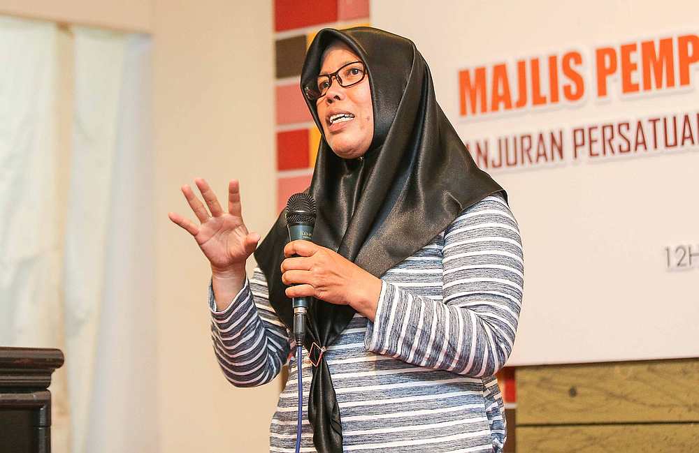Parking attendant Rohana Hamzah chooses her current vocation after she stopped working in a factory six years ago. — Picture by Farhan Najib