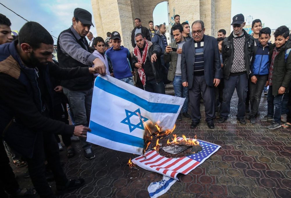 Palestinian demonstrators burn the Israeli and US flags during a protest against a US-brokered Middle East peace plan in Rafah in the southern Gaza Strip, on February 1, 2020. u00e2u20acu201d AFP pic