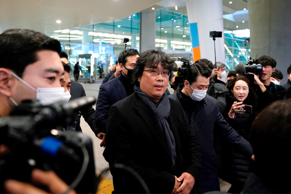 Director of four Oscar award-winning film u00e2u20acu02dcParasiteu00e2u20acu2122 Bong Joon-ho is escorted by security personnel as he leaves Incheon International Airport February 16, 2020. u00e2u20acu201d Reuters pic