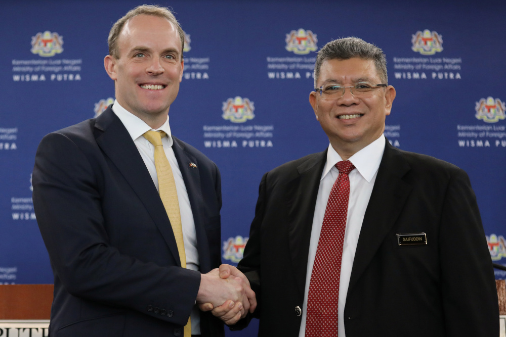 Britainu00e2u20acu2122s foreign secretary Dominic Raab shakes hands with Malaysiau00e2u20acu2122s Foreign Minister Datuk Saifuddin Abdullah after a joint news conference in Putrajaya February 11, 2020. u00e2u20acu201d Reuters pic