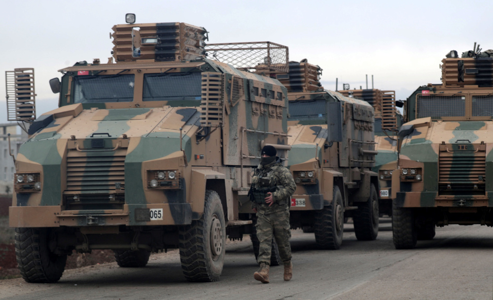 A Turkish soldier walks near Turkish military vehicles in Hazano near Idlib February 11, 2020. u00e2u20acu201d Reuters pic 