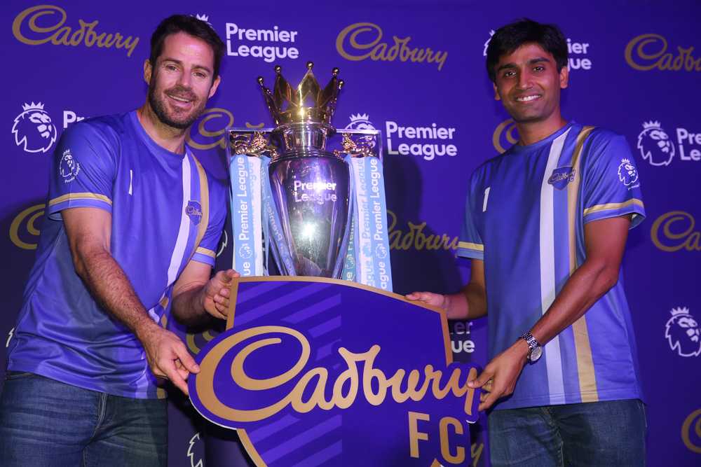 Jamie Redknapp (left) and Rahul Mathur pose with the EPL trophy at the launch of Cadbury FCu00e2u20acu2122s campaign. u00e2u20acu201d Picture by Choo Choy May