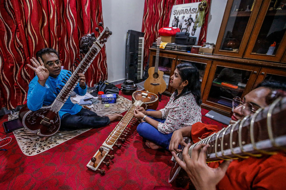Samuel Dass making sure that his students are using the right technique to pluck the strings of the sitar. u00e2u20acu201d Picture by Hari Anggara