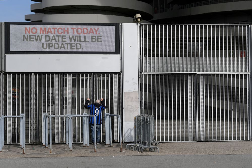 A man stands outside the San Siro stadium after the Inter Milan v Sampdoria Serie A match was cancelled due to an outbreak of the coronavirus in Lombardy and Veneto, in Milan February 23, 2020. u00e2u20acu201d Reuters picnn