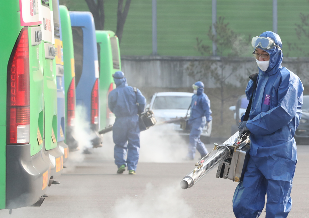 Workers from a disinfection service spray disinfectant as part of preventive measures against the spread of Covid-19, at a public bus terminal in Seoul February 20, 2020. u00e2u20acu201d AFP pic 