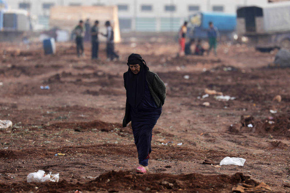 An internally displaced woman walks at a makeshift camp in Azaz, Syria February 19, 2020. u00e2u20acu201d Reuters pic