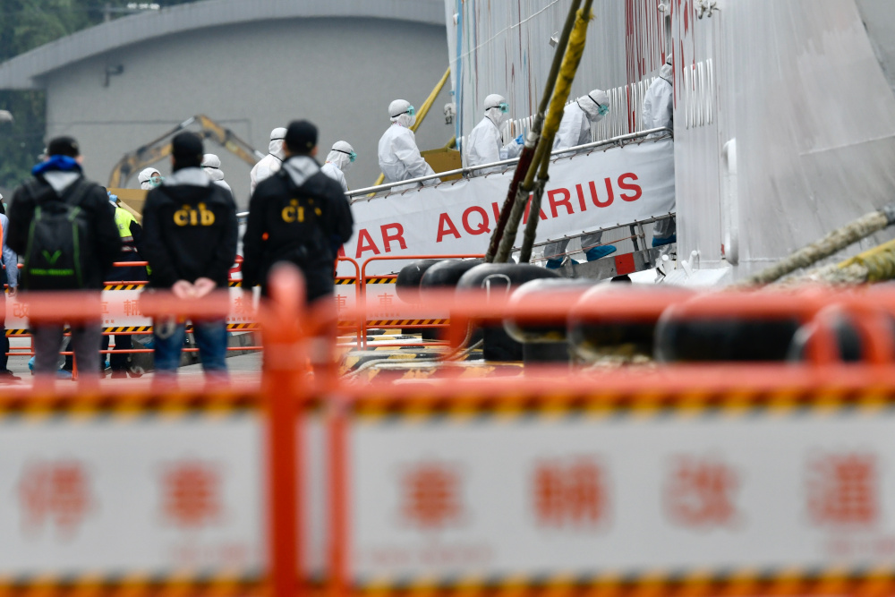 Taiwanese Centres for Disease Control (CDC) members wearing protective gears embark on the Superstar Aquarius cruise ship at the Keelung Harbour, northern Taiwan, February 8, 2020. u00e2u20acu201d AFP pic 