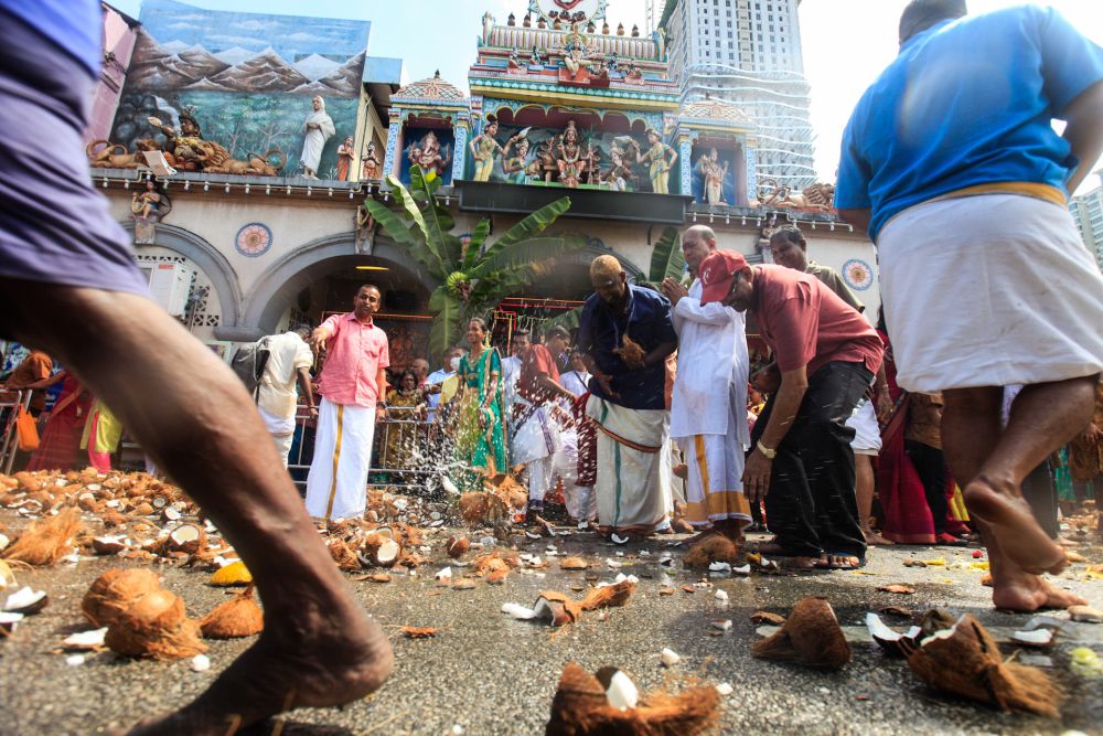 Devotees smash coconuts along Jalan Dato Keramat, George Town, as the silver chariot passes by, February 7, 2020. u00e2u20acu2022 Picture by Sayuti Zainudin 