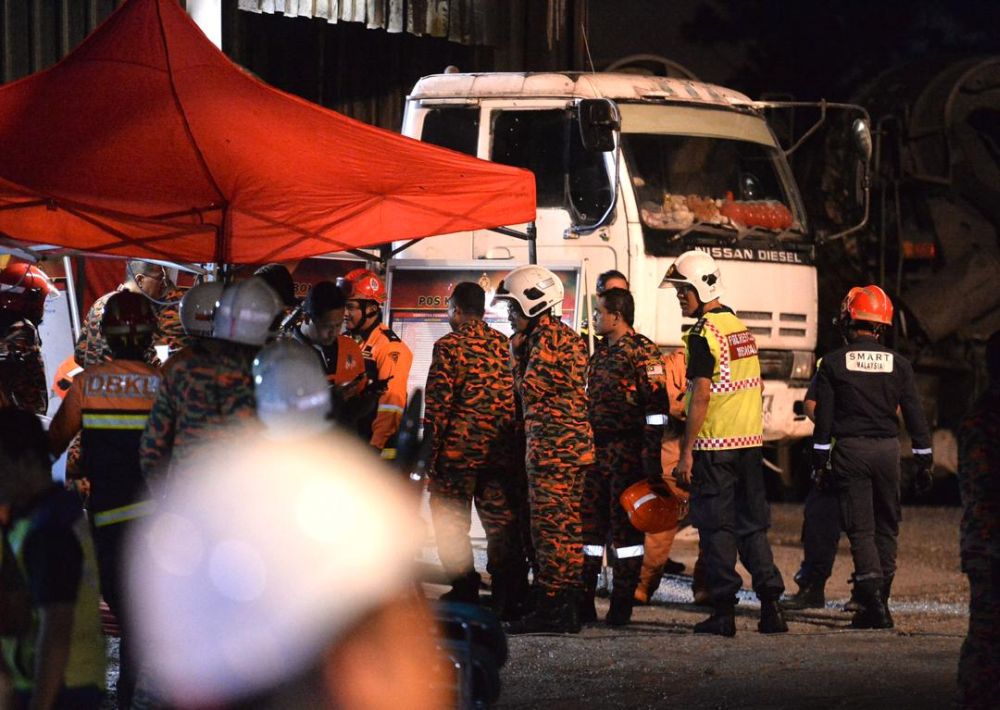 Kuala Lumpur Fire and Rescue personnel are pictured at The Address condominium in Taman Desa, where a concrete slab collapsed from the buildingu00e2u20acu2122s sixth floor on February 14, 2020. 