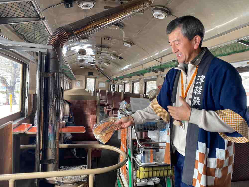 An attendant sells dried squid onboard, a popular snack among locals. ― Picture by Melanie Chalil