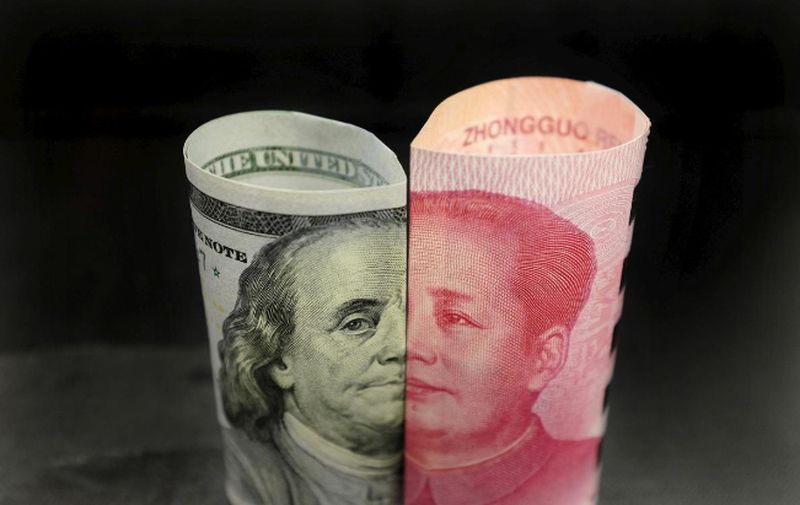 A Benjamin Franklin US 100 dollar banknote and a Chinese 100 yuan banknote with late Chinese Chairman Mao Zedong are seen in this picture illustration in Beijing, China, January 21, 2016. u00e2u20acu201d Reuters pic
