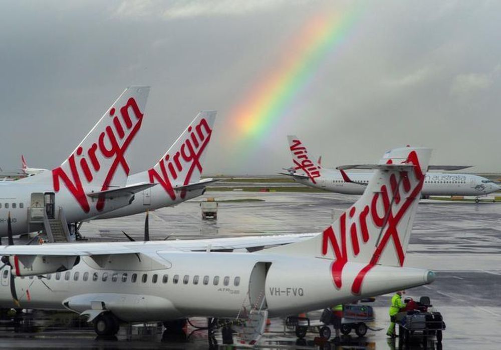 A rainbow from a passing rain shower sits over Virgin Australia aircraft at Sydneyu00e2u20acu2122s Airport in Australia, August 5, 2016. u00e2u20acu201d Reuters pic
