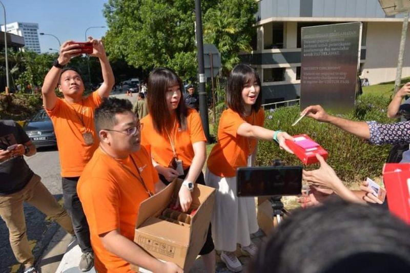 Xiaomi Malaysia staff hands out 20,000 mAh power banks to journalists outside Istana Negara February 26, 2020. u00e2u20acu201d Picture via SoyaCincau