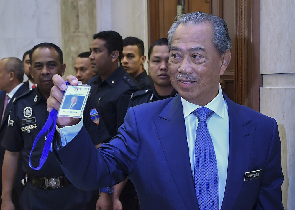 Tan Sri Muhyiddin Yassin shows his PMO pass on his first day in office as prime minister at Perdana Putra March 2, 2020. u00e2u20acu201d Bernama pic
