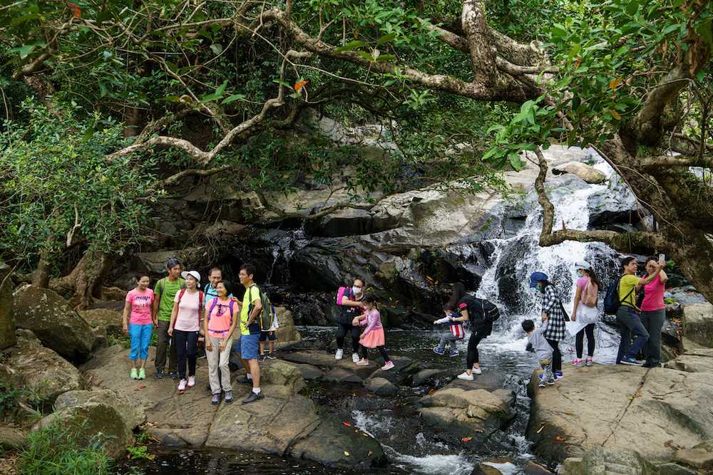 People stop for a break on a hiking trail near a waterfall in the Tseung Kwan O area of Hong Kong March 1, 2020. u00e2u20acu201d AFP pic