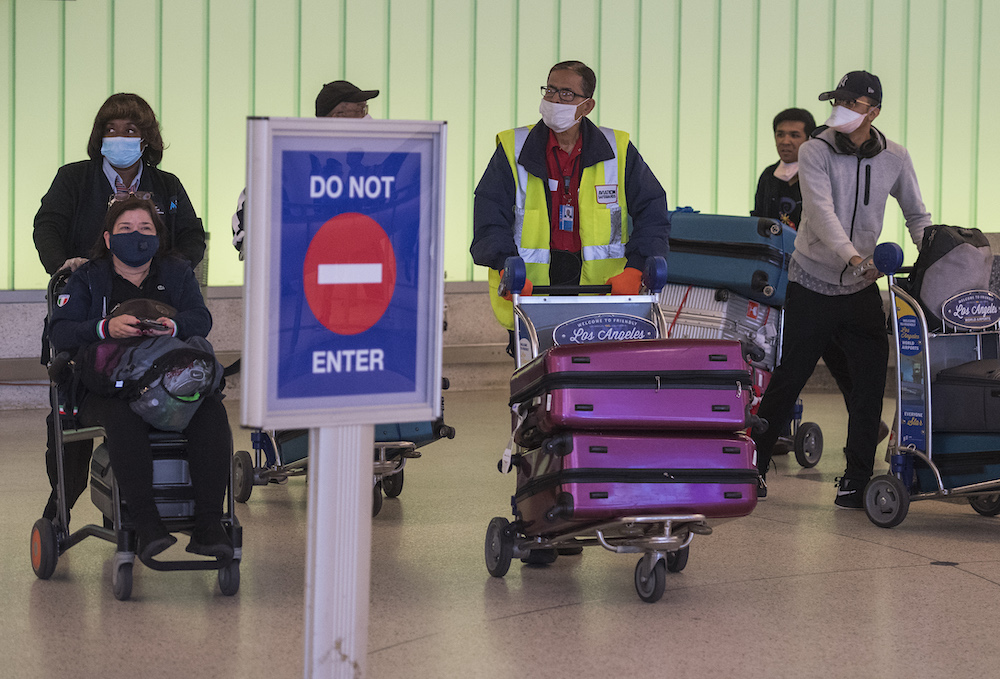 Passengers wear face masks to protect against the Covid-19 after arriving at the LAX airport in Los Angeles March 5, 2020. u00e2u20acu201d AFP pic