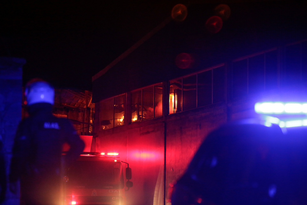 A police officer stands guard next to the burning premises of the community centre of NGO u00e2u20acu02dcOne Happy Familyu00e2u20acu2122 on the island of Lesbos March 7, 2020. u00e2u20acu201d Reuters pic