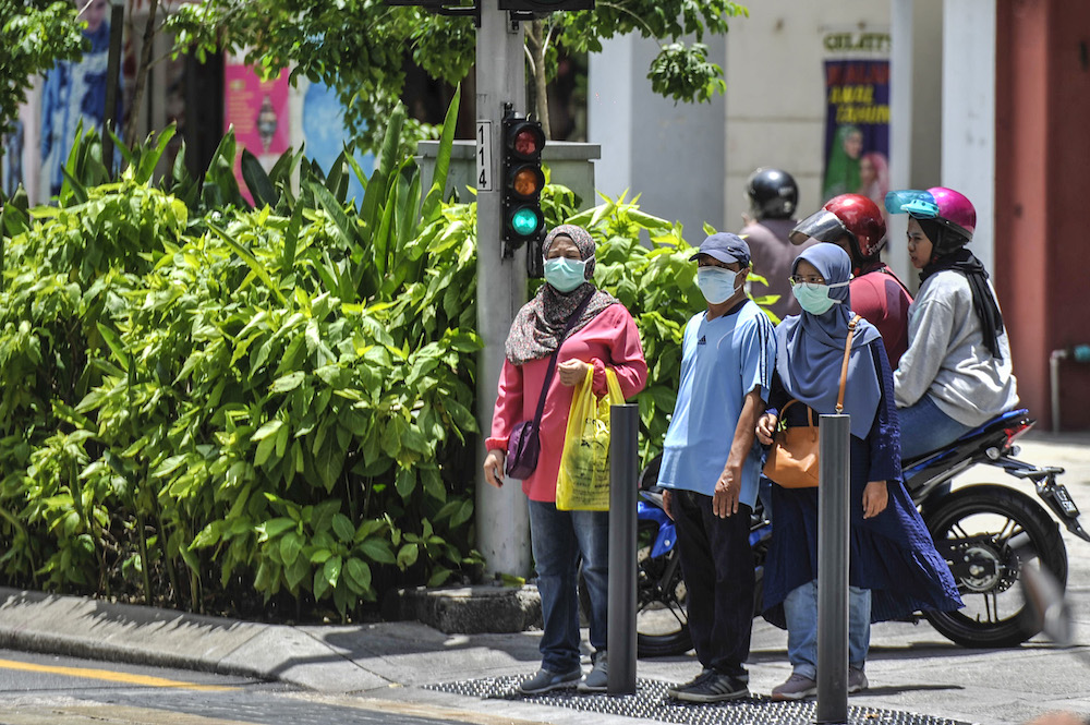 People are seen wearing face masks to protect themselves against the new coronavirus in Kuala Lumpur March 15, 2020. u00e2u20acu2022 Picture by Shafwan Zaidon