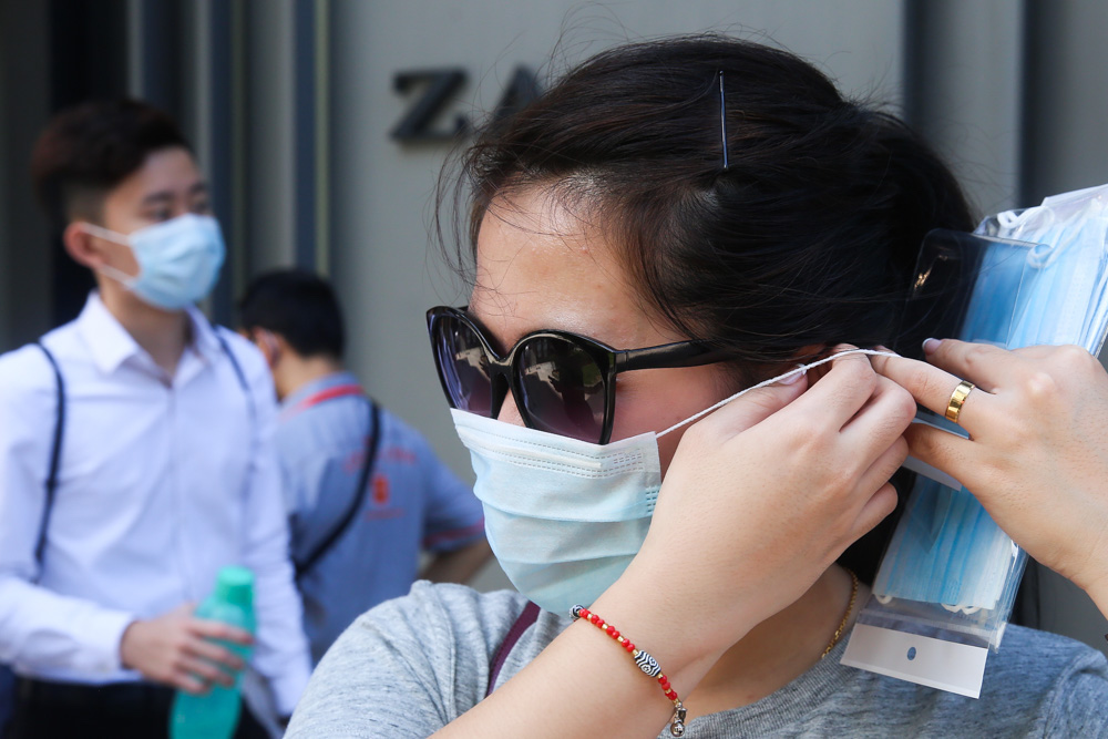 A lady is seen adjusting her masks along Jalan Bukit Bintang, Kuala Lumpur March 16 2020. u00e2u20acu201d Picture by Choo Choy May