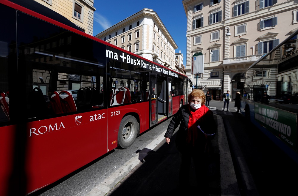 A woman wearing a protective face mask stands in a bus stop, after the government decree to close schools, cinemas, and urge people to work from home and not stand closer than one metre to each other in Rome March 5, 2020. u00e2u20acu201d Reuters pic