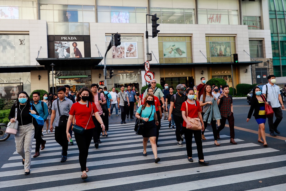 Pedestrians wearing protective face masks cross a street outside a shopping mall amid new cases of coronavirus, in Manila March 11, 2020. u00e2u20acu201d Reuters pic