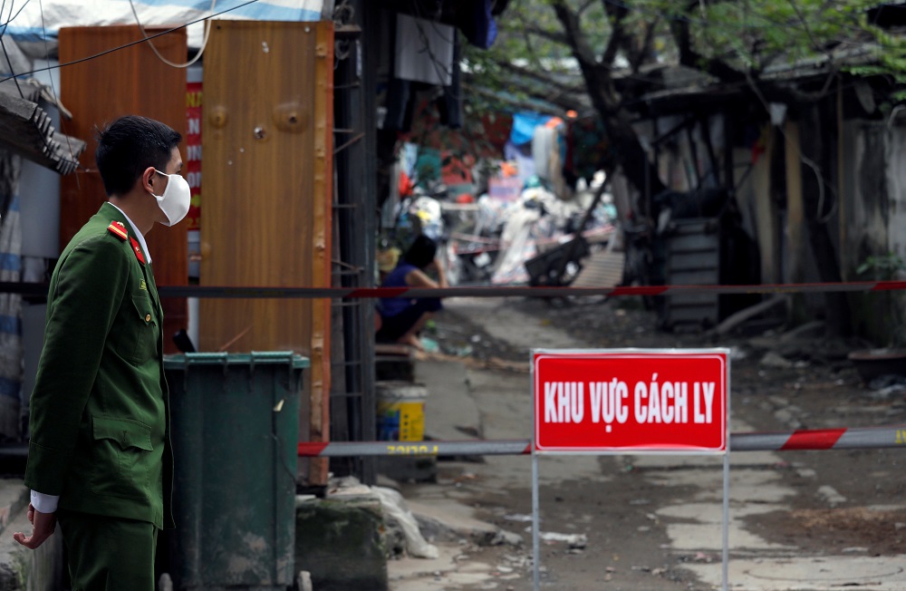 A police officer wears a protective mask as he guards near the house of a coronavirus-infected patient at a quarantined area in Hanoi March 13, 2020. u00e2u20acu201d Reuters pic