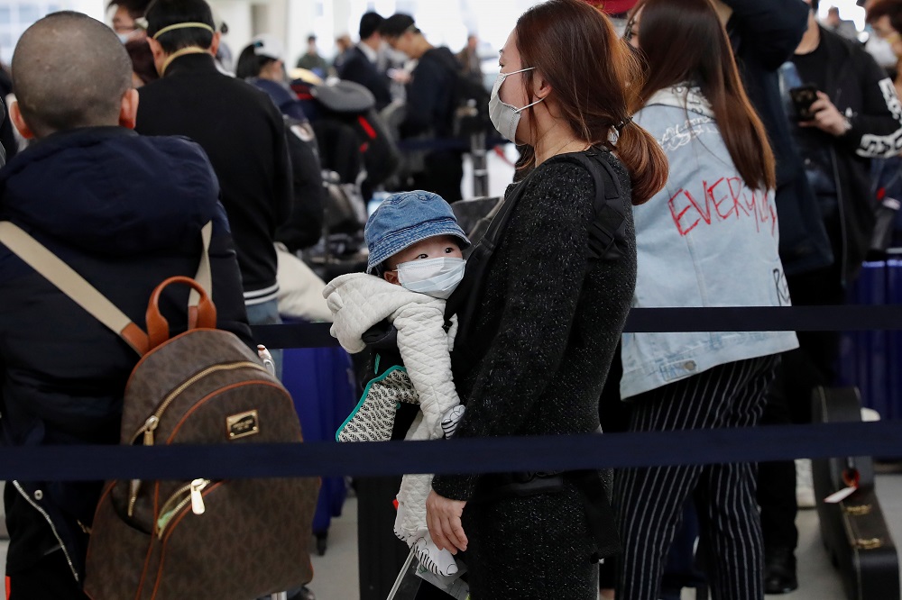 Passengers waiting to check in for an Air China flight are seen with face masks on, after further cases of coronavirus were confirmed in New York, at JFK International Airport in New York March 13, 2020. u00e2u20acu201d Reuters pic