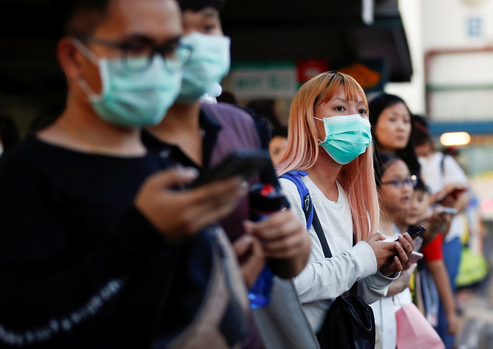 Commuters wait for a transport to leave the Woodlands Causeway across to Singapore from Johor, hours before Malaysia imposes a lockdown on travel due to the coronavirus outbreak March 17, 2020. u00e2u20acu201d Reuters pic