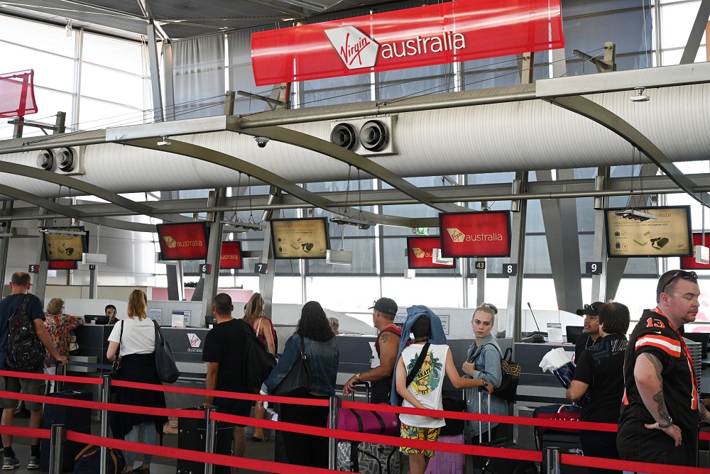 Travellers wait in line at a Virgin Australia Airlines counter at Kingsford Smith International Airport, following the coronavirus outbreak, in Sydney March 18, 2020. u00e2u20acu201d Reuters pic