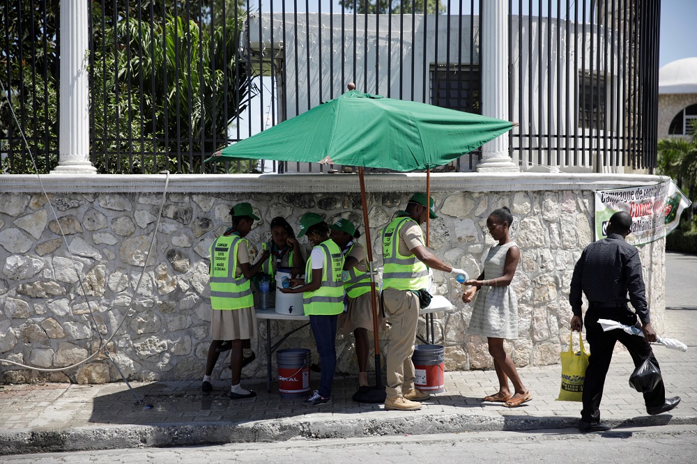 Haitian Boy and Girl Scouts at a hand-washing station offer a hand wash to pedestrians to prevent the spread of coronavirus disease in Port-au-Prince, Haiti March 23, 2020. u00e2u20acu201d Reuters pic