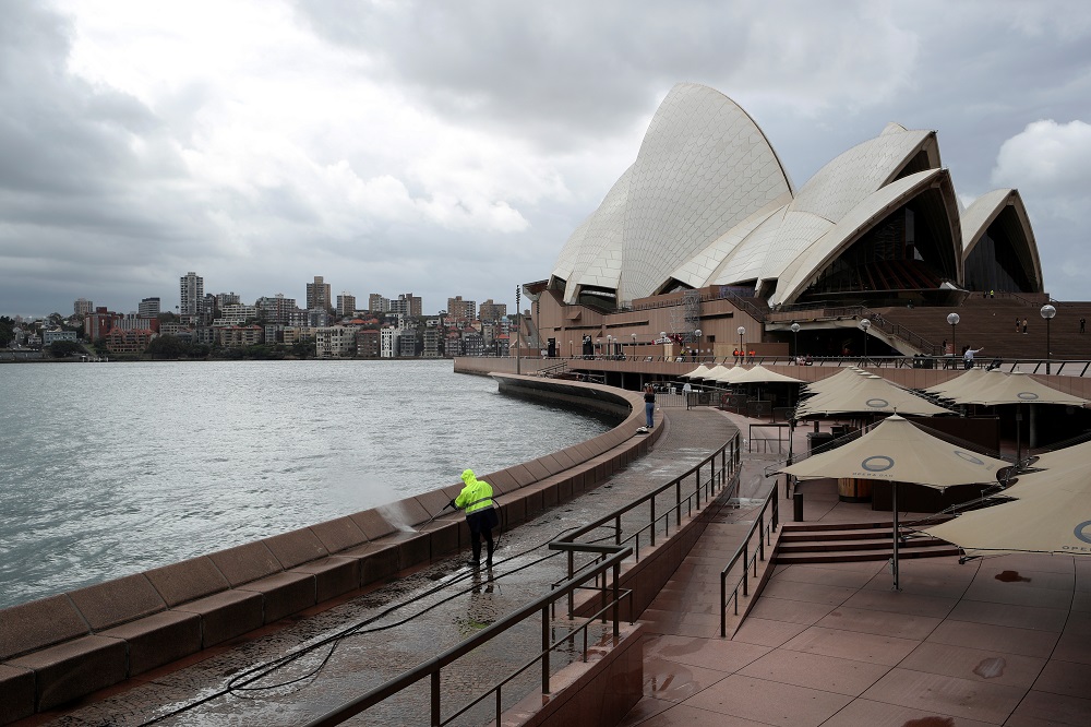 A worker cleans the waterfront area of the Sydney Opera House March 26, 2020. u00e2u20acu201d Reuters pic