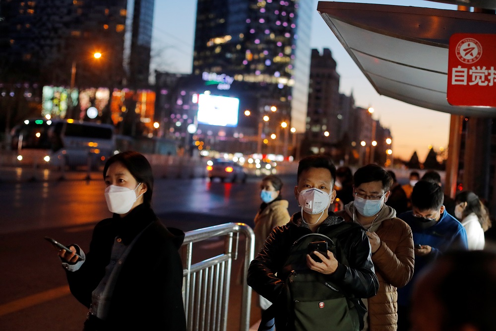Commuters wearing protective face masks wait at a bus stop as businesses are starting to revert to a normal work routine after an outbreak of the coronavirus disease in Beijing March 27, 2020. u00e2u20acu201d Reuters pic