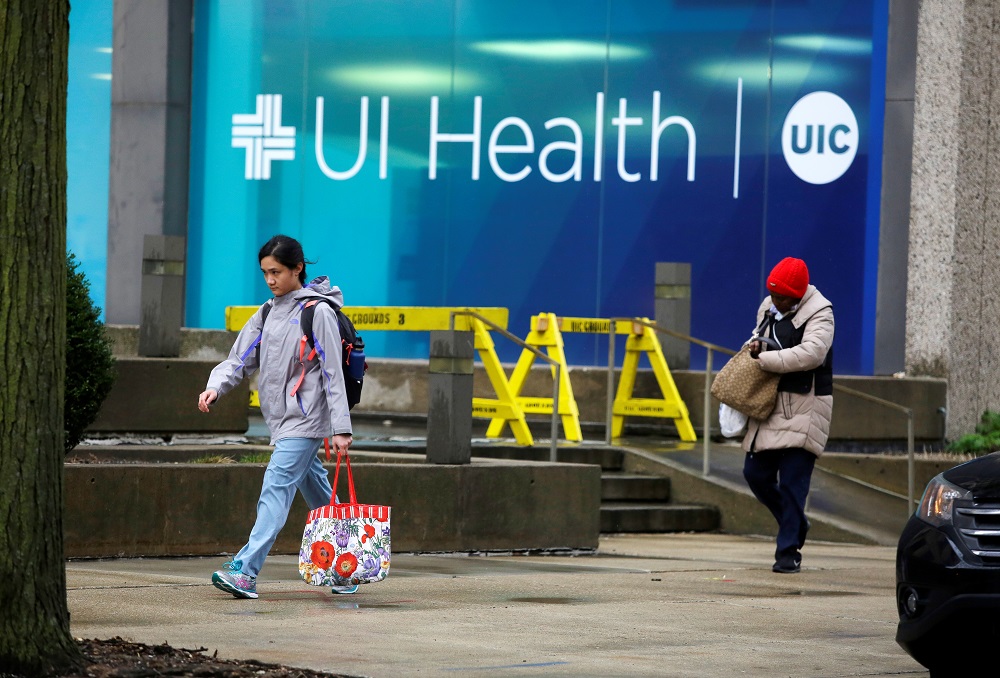 People walk past the University of Illinois Hospital as the Illinois Nurses Association reports 12 registered nurses tested positive for the coronavirus disease, in Chicago US March 27, 2020. u00e2u20acu201d Reuters pic