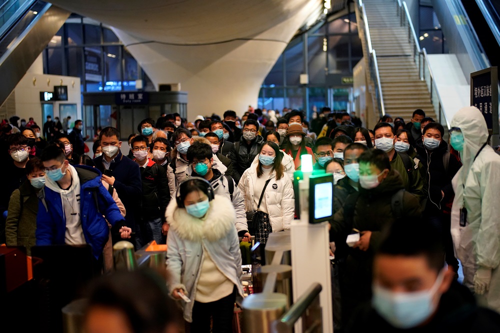 People wearing face masks arrive at a railway station in Wuhan on the first day of inbound train services resumed following the novel coronavirus disease outbreak, in Wuhan March 28, 2020. u00e2u20acu201d Reuters pic