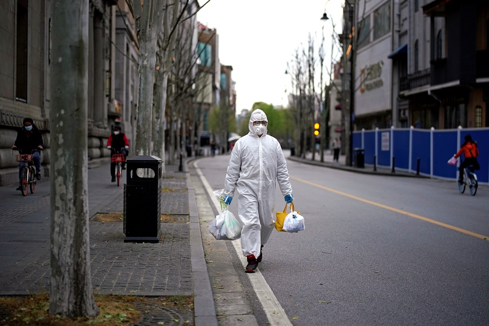 A man wearing a hazmat suit walks on a street in Wuhan, Hubei province, the epicentre of Chinau00e2u20acu2122s coronavirus disease outbreak March 28, 2020. u00e2u20acu201d Reuters pic
