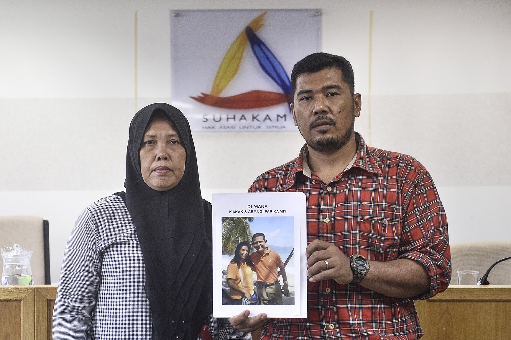 Ruth Hilmy's sister, Ram Ram Elisabeth Sitepu (left), and her younger brother Iman Sitepu holding a picture of Ruth and her husband Joshua Hilmy during a press conference in Kuala Lumpur March 4, 2020. u00e2u20acu201d Picture by Miera Zulyana