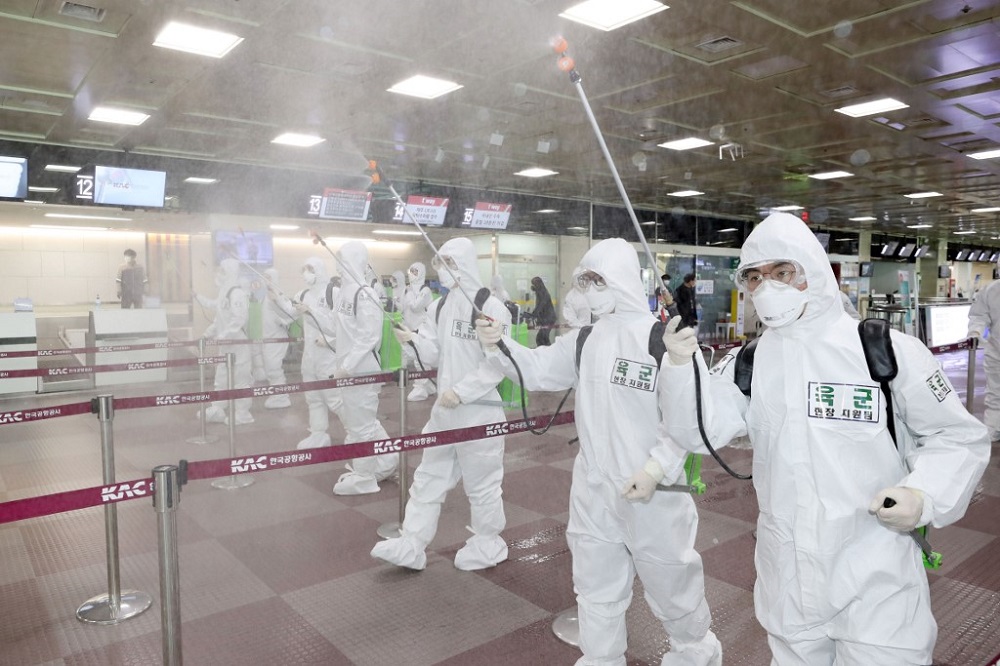 South Korean soldiers wearing protective gear spray disinfectant to help prevent the spread of the Covid-19 coronavirus, at the Daegu International Airport in Daegu March 6, 2020. u00e2u20acu201d AFP pic