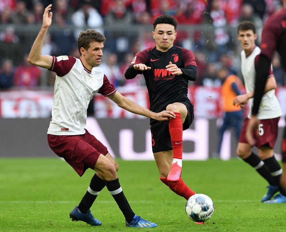 Bayern Munich's striker Thomas Mueller (left) and Swiss midfielder Ruben Vargas (right) vie for the ball during the German first division football Bundesliga match in Munich March 8, 2020. u00e2u20acu201d AFP pic