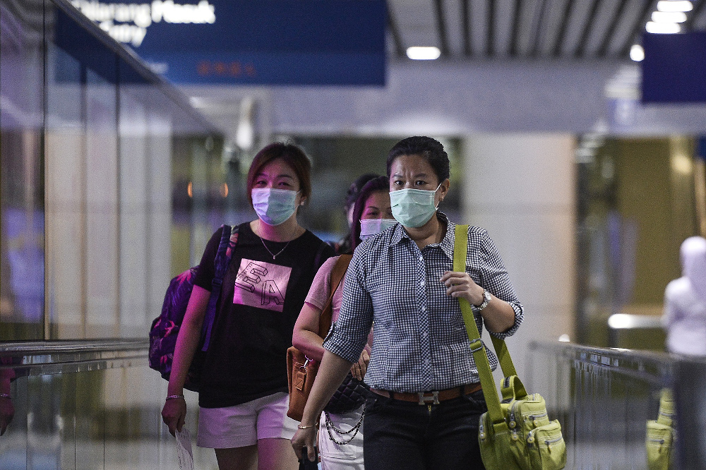 Passengers wearing masks at KLIA March 10, 2020. u00e2u20acu201d Picture by Miera Zulyana