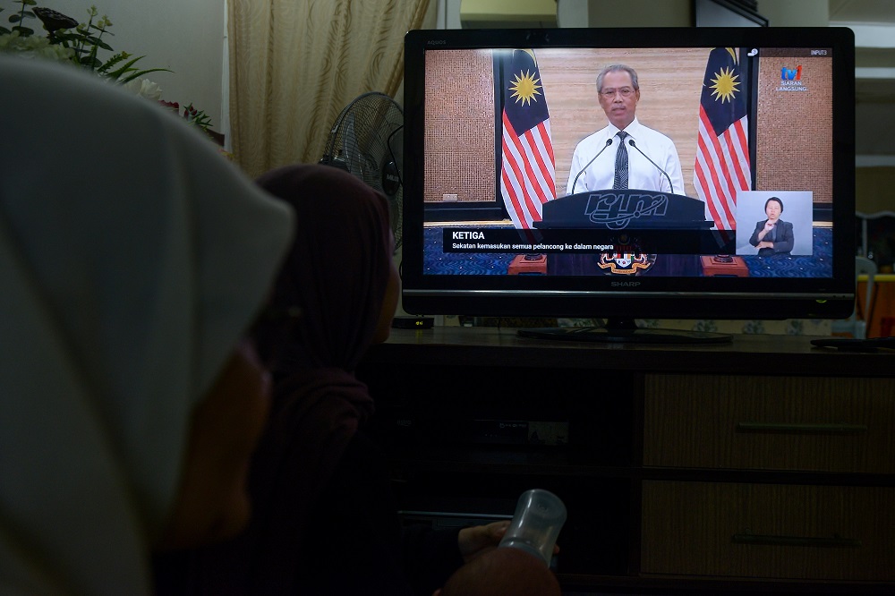 People watching the live telecast of Prime Minister Tan Sri Muhyiddin Yassinu00e2u20acu2122s announcement of a nationwide movement control order due to the Covid-19 pandemic in Kuala Lumpur March 16, 2020. u00e2u20acu201d Picture by Miera Zulyana