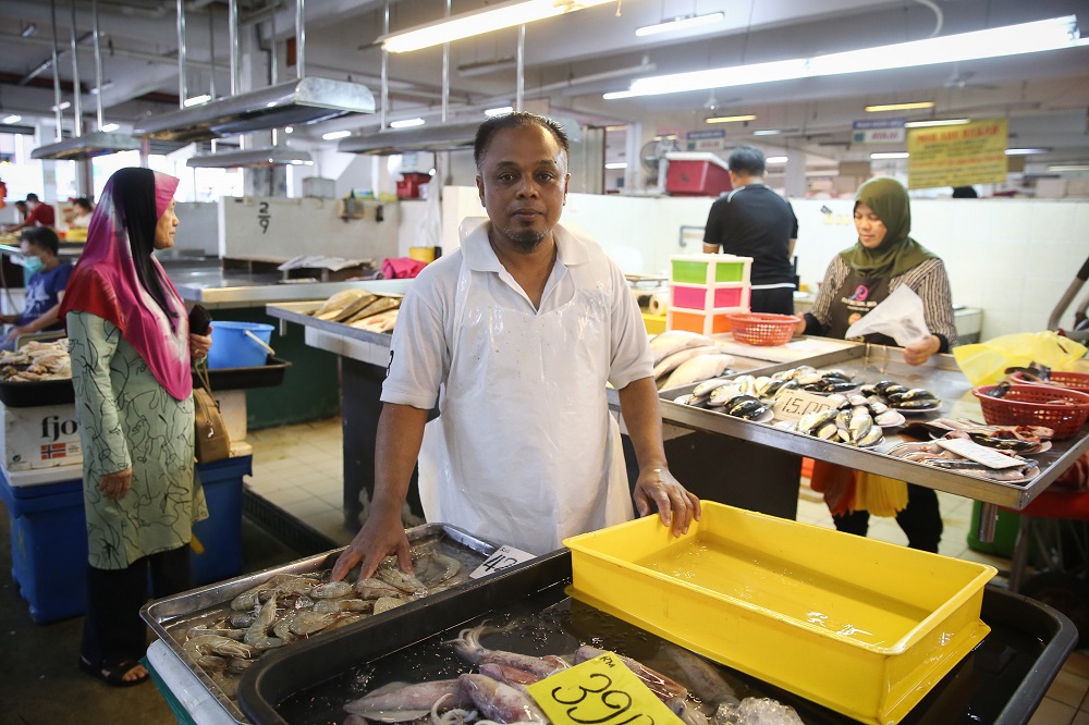 Fishmonger Azman Mohammad poses for a picture next to his stall at the SS15 wet market in Subang Jaya March 18, 2020. — Picture by Yusof Mat Isa