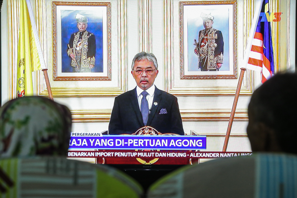 People watch a live telecast of Yang di-Pertuan Agong Al-Sultan Abdullah Ri'ayatuddin Al-Mustafa Billah Shah regarding the movement control order due to the Covid-19 pandemic in Kuala Lumpur March 20, 2020. u00e2u20acu201d Picture by Hari Anggara