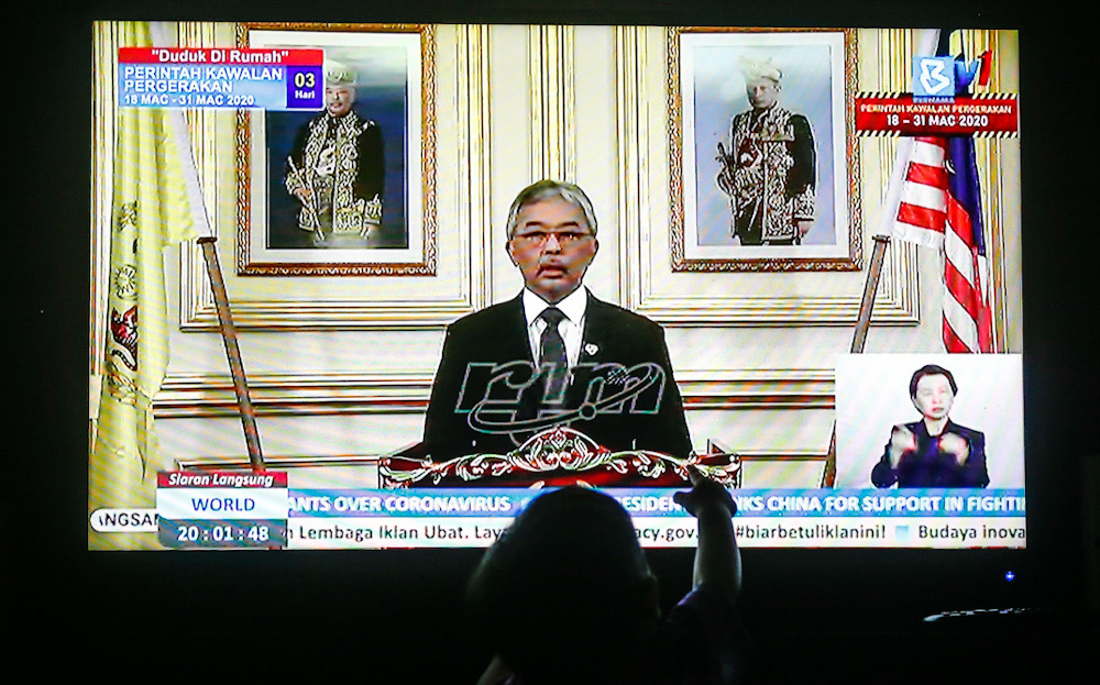 People watch a live telecast of Yang di-Pertuan Agong Al-Sultan Abdullah Ri'ayatuddin Al-Mustafa Billah Shah regarding the movement control order due to the Covid-19 pandemic in Kuala Lumpur March 20, 2020. u00e2u20acu201d Picture by Sayuti Zainudin