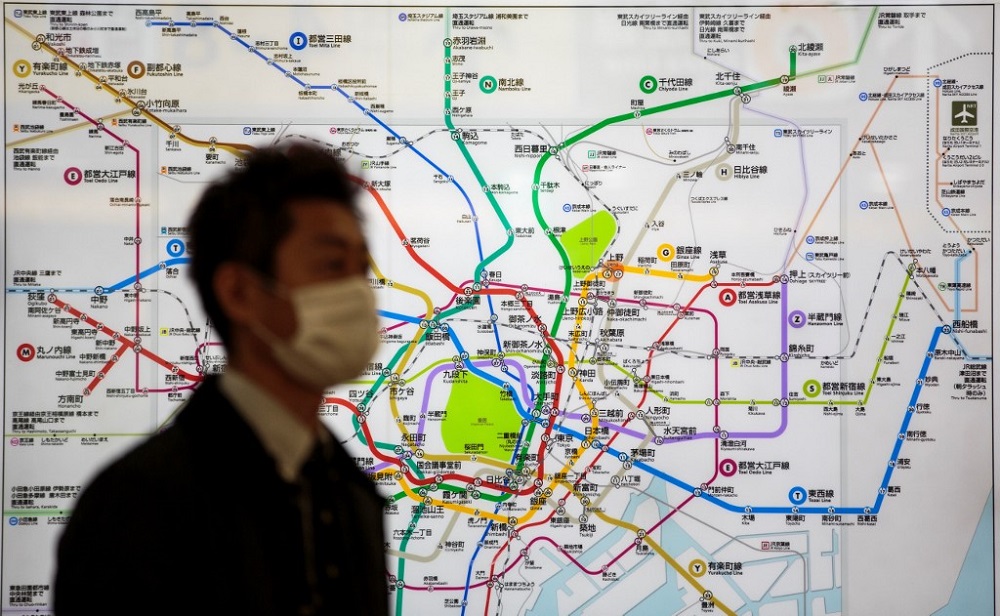 A man wearing a face mask, amid concerns of the Covid-19 coronavirus, walks past a Tokyo Metro map at a station in Tokyo March 19, 2020. u00e2u20acu201d AFP pic