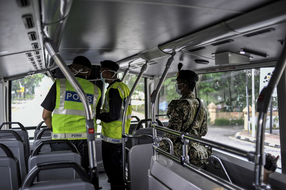 Malaysian Armed Forces and police personnel are seen at one of the roadblocks in Kuala Lumpur March 22, 2020. u00e2u20acu201d Picture by Shafwan Zaidon