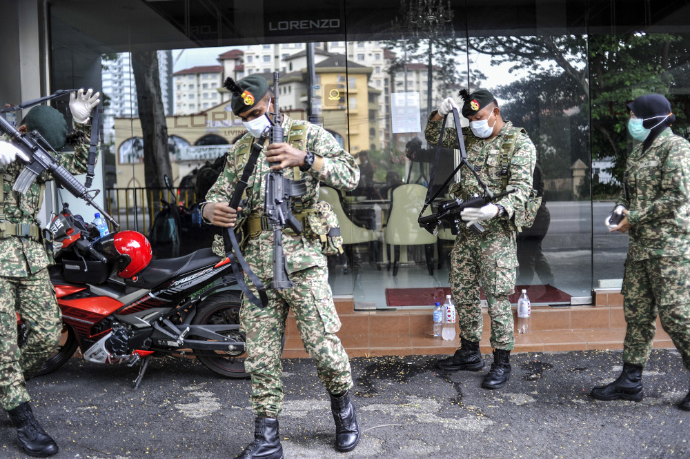Malaysian Armed Forces and police personnel are seen at one of the roadblocks in Kuala Lumpur March 22, 2020. u00e2u20acu201d Picture by Shafwan Zaidon